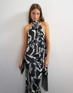 Model wearing Satin asymmetric halter neck maxi dress with fringed scarf in animal print