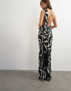Model wearing Satin asymmetric halter neck maxi dress with fringed scarf in animal print