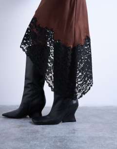 Model wearing Satin asymmetric lace hem midaxi skirt in brown with black lace 