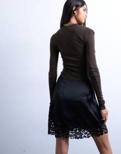 Model wearing Satin asymmetric mini skirt with lace trim in black