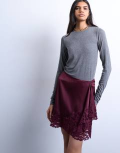 Model wearing Satin aymmetric mini skirt with lace trim in port royale