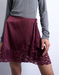 Model wearing Satin aymmetric mini skirt with lace trim in port royale