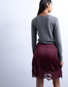 Model wearing Satin aymmetric mini skirt with lace trim in port royale