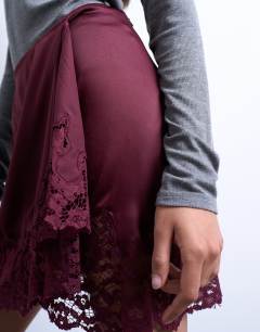 Model wearing Satin aymmetric mini skirt with lace trim in port royale