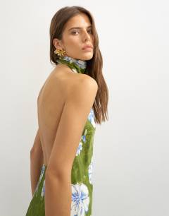Model wearing Satin bias collapsed funnel halter neck maxi dress with open back in green floral