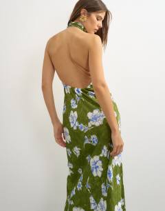Model wearing Satin bias collapsed funnel halter neck maxi dress with open back in green floral