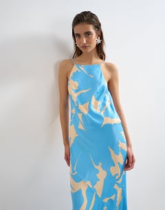 Model wearing Satin bias halter neck open scoop back maxi dress in blue floral