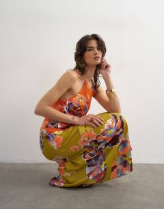 Model wearing Satin bias halter neck open scoop back maxi dress in bold contrast floral