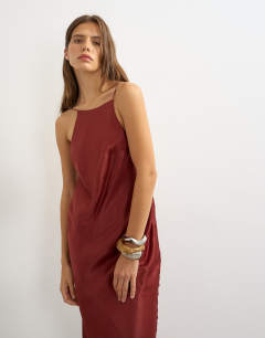 Model wearing Satin bias halter neck open scoop back maxi dress in burnt red