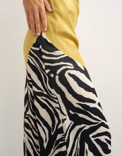 Model wearing Satin bias halter neck open scoop back maxi dress in colour block animal