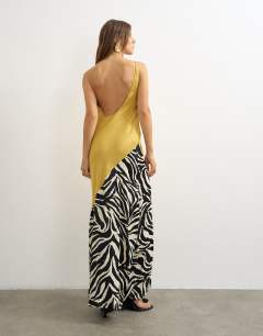 Model wearing Satin bias halter neck open scoop back maxi dress in colour block animal