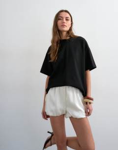 Model wearing Satin bubble shorts in ivory