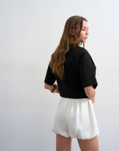 Model wearing Satin bubble shorts in ivory