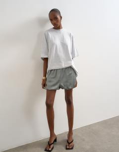 Model wearing Satin bubble shorts in sage