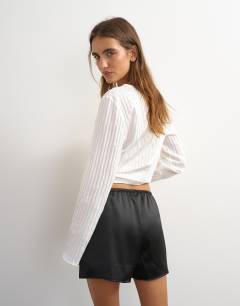 Model wearing Satin button detail short in black