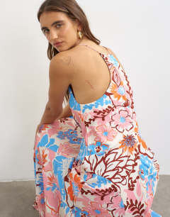 Model wearing Satin cut away racer neck full skirt maxi dress in blue and pink bold floral