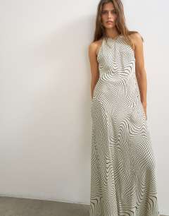 Model wearing Satin cut away racer neck full skirt maxi dress in mono wavy print