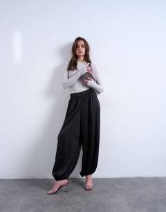 Model wearing Satin deep waistband balloon trouser in black