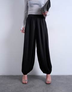 Model wearing Satin deep waistband balloon trouser in black