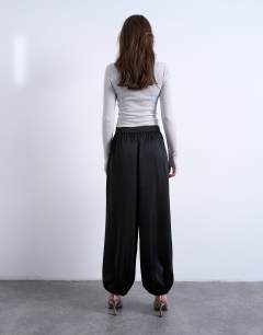 Model wearing Satin deep waistband balloon trouser in black