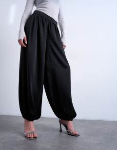 Model wearing Satin deep waistband balloon trouser in black