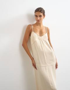 Model wearing Satin double layered cami maxi dress with seam details in stone