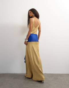 Model wearing Satin dropped waist maxi dress with contrast tie belt in gold and blue