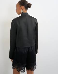 Model wearing Satin drummer boy jacket in black