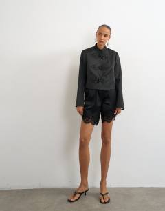 Model wearing Satin drummer boy jacket in black
