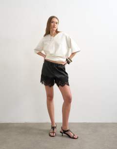 Model wearing Satin feel lace insert short in black