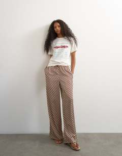 Model wearing Satin feel straight leg trouser in burgundy stripe