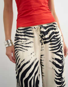 Model wearing Satin feel straight leg trouser in zebra print