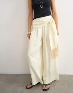 Model wearing Satin feel wrap co-ord trouser with fringe detail in cream