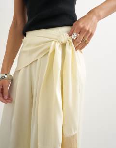 Model wearing Satin feel wrap co-ord trouser with fringe detail in cream