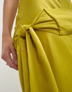 Model wearing Satin grown on neck dropped waist sash maxi dress in golden olive
