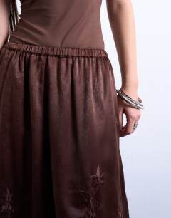 Model wearing Satin hanky hem midi skirt with lace embroidery in chocolate