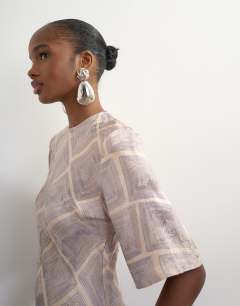 Model wearing Satin jacquard slash neck maxi dress in blue square print