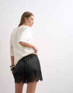 Model wearing Satin lace insert short in black