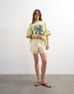 Model wearing Satin lace insert short in ecru