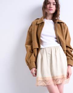 Model wearing Satin lace petticoat mini skirt with contrast lace in oyster