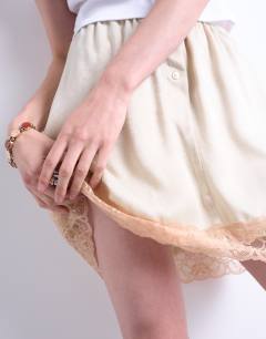 Model wearing Satin lace petticoat mini skirt with contrast lace in oyster