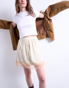 Model wearing Satin lace petticoat mini skirt with contrast lace in oyster