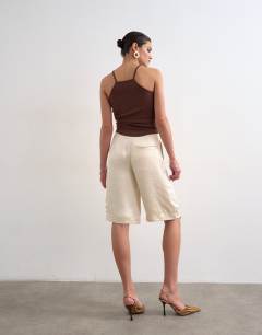 Model wearing Satin longline cargo short in ecru