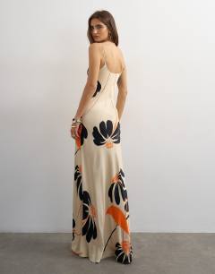 Model wearing Satin low scoop flood length slip dress in black and orange bold floral