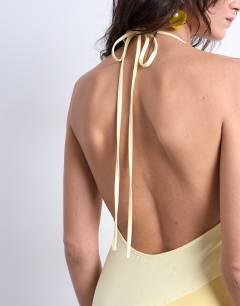 Model wearing Satin maxi occasion halter dress in yellow gradient