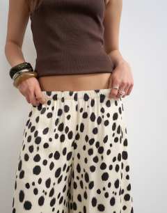 Model wearing Satin pull on A-line wide leg trouser in abstract animal