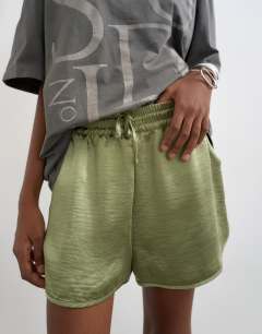 Model wearing Satin runner short with deep waistband in green