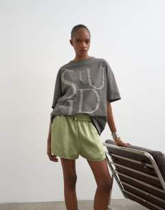 Model wearing Satin runner short with deep waistband in green