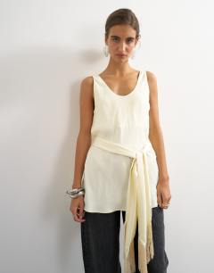Model wearing Satin scoop neck cami with fringe detail tie in ivory