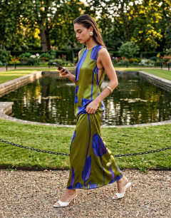 Model wearing Satin sleeveless asymmetric drape maxi dress in green and blue floral